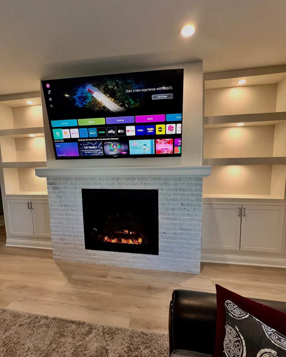 Illuminated white built-in fireplace.