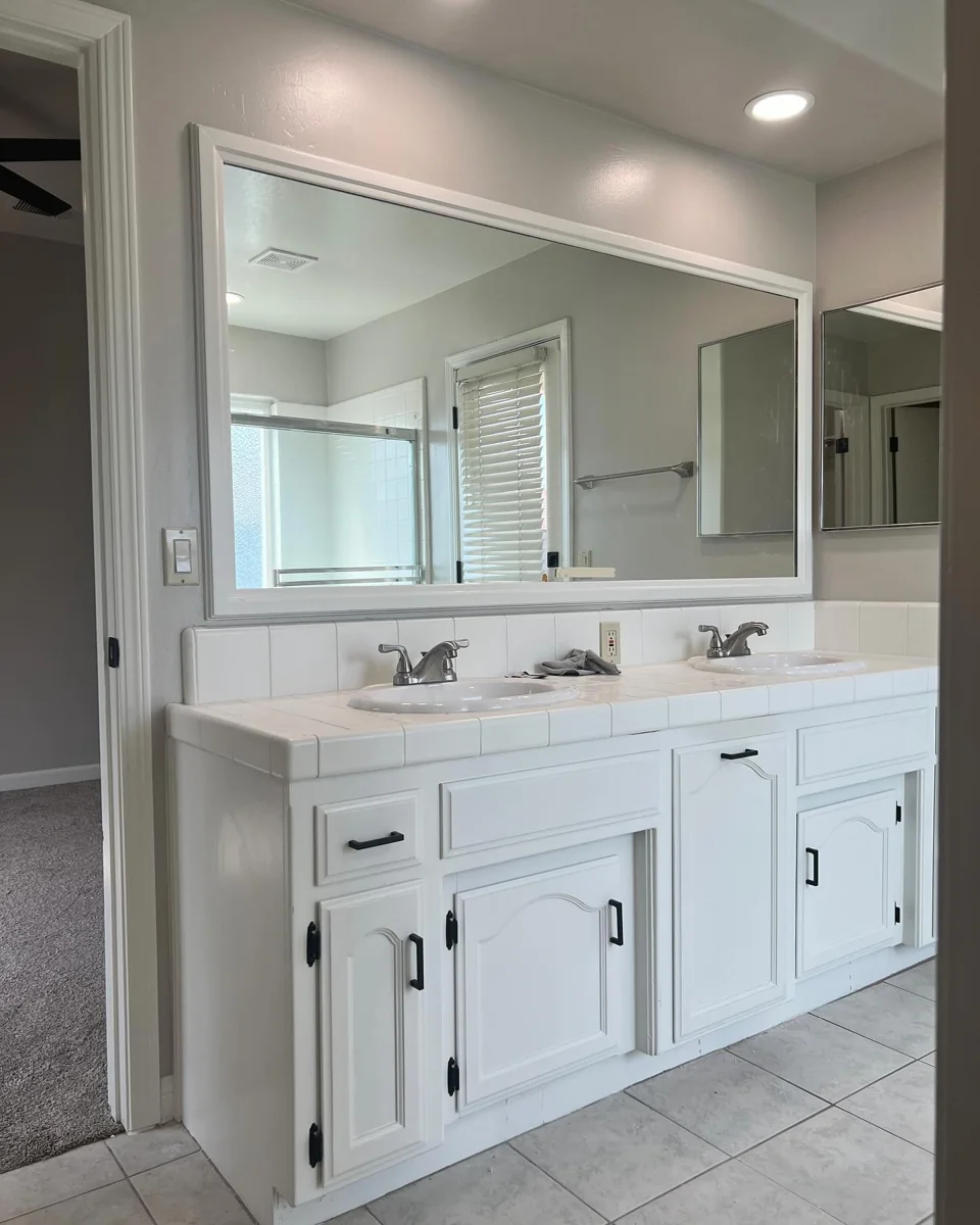 White double vanity and large mirror.