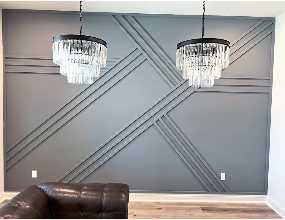 Geometric trim accent wall with chandeliers.