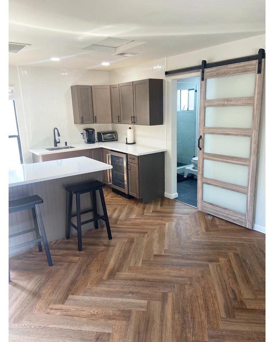 Herringbone floor and barn-door room.