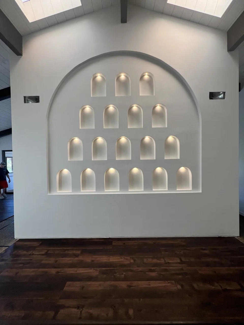 An arched feature wall with individually illuminated display niches.