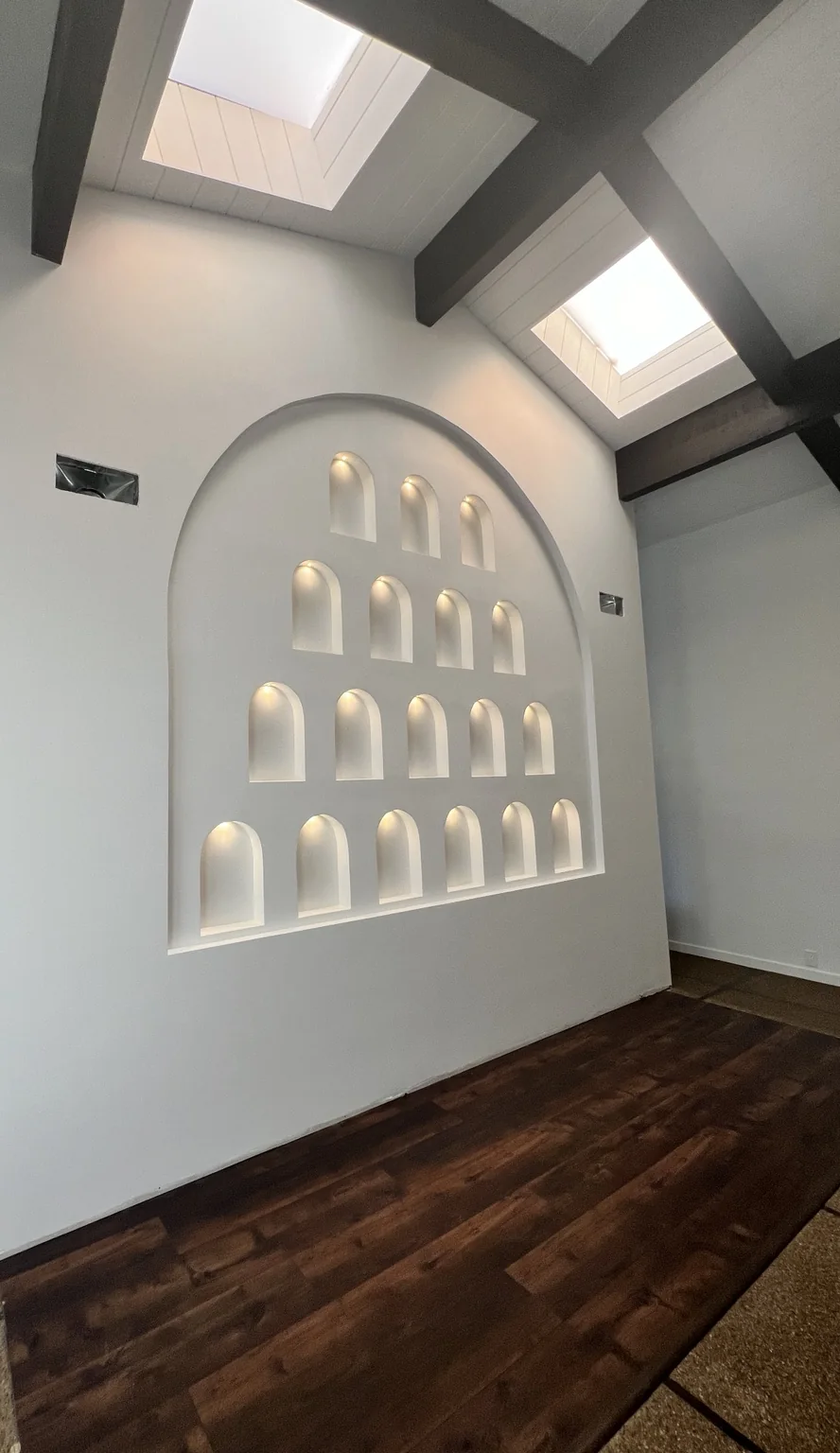 An angled view of the illuminated niche wall and surrounding interior.