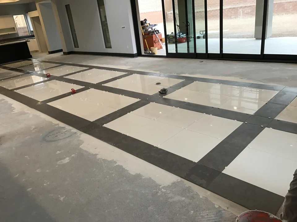 Work in progress: tile spacers and lifting tools remain in place during installation.